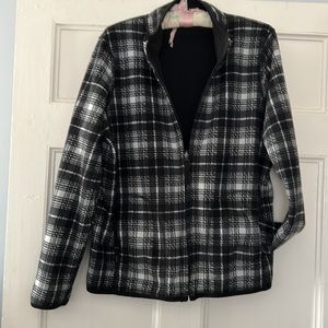 Reversible Woman’s full, zip, fleece jacket, size L, black and white.